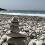 Pedras empilhadas na praia convidam à reflexão